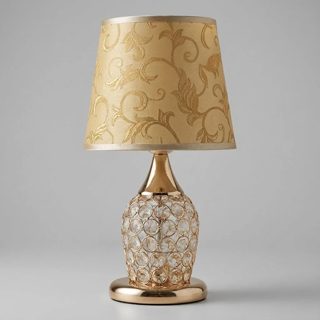 Bordslampa med kristallfot och guldtrumskärm i en elegant interiör