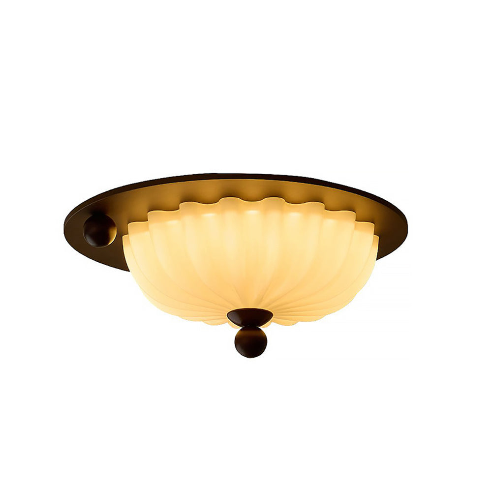 Taklampa i glas med integrerad LED sedd framifrån mot vit bakgrund